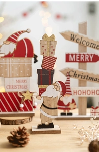 Detailed view of red wooden Santa Claus and Merry Christmas welcome sign decor