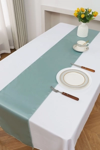 Detailed view of the smooth teal satin table runner with high-gloss finish and fine texture