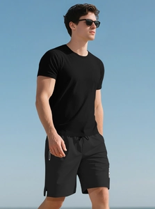 Men's summer black heavy cotton fitness Henley t-shirt and shorts set against blue sky