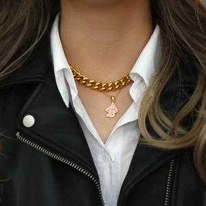 Golden 11mm Cuban chain necklace with pink mushroom pendant on a model in leather jacket