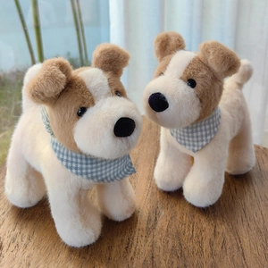 Cute Fox Terrier plush toy puppy with checkered scarf on a warm wooden home background
