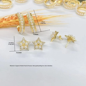 Detailed view of 18k gold plated C-shape hoop and star stud earrings with white pearls