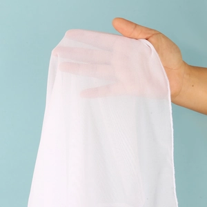 Close-up of white semi-transparent mesh fabric showing breathable micro-mesh texture