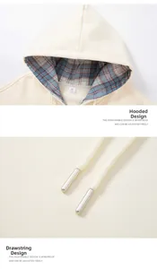 Detail of cream hoodie showing warm sherpa lining and plaid fabric inside the hood