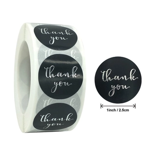 Detail of 1 inch black and silver Thank You stickers roll with size measurement