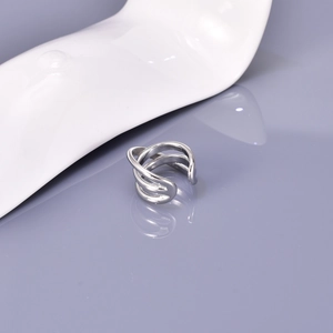 Macro shot of silver multi-layer crossover open ring with polished metallic finish