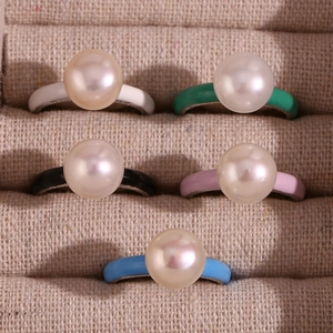 Macro detail of colorful enamel pearl rings in white, green, black, pink and blue
