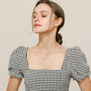 Minimalist s925 silver infinity pendant necklace with turquoise on a model's neck