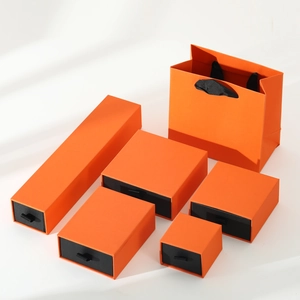 Detail view of premium orange drawer jewelry boxes and matching gift bag set