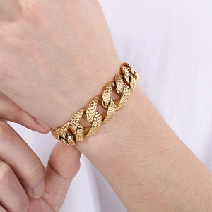 Detailed close-up of 18mm gold hammered Cuban link bracelet on a wrist