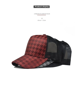 Detail of houndstooth plaid mesh trucker hats in red, grey, and black colorways