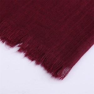 Detail view of wine red cotton linen scarf showing plain weave texture and fringe edges