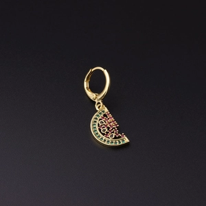 Macro detail of gold watermelon hoop earring with green and red cubic zirconia stones