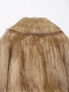 Detailed macro view of brown faux fur texture on the collar and upper back of the coat