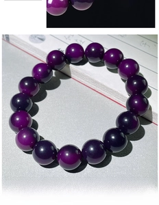 Close-up of polished purple bodhi seed prayer beads placed on vintage books