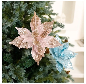 Pink velvet artificial poinsettia with glitter sequins on a green Christmas tree