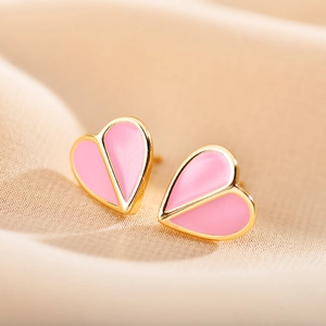 Elegant gold-tone and pink spade heart stud earrings on a luxury satin background