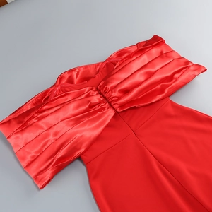 Close-up of red off-shoulder evening dress featuring pleated satin fabric texture