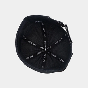 Detail view of denim docker cap interior with New Cap printed straps and adjustable buckle