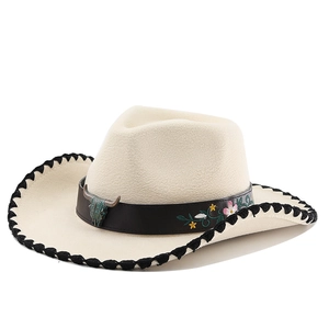 Detail of western felt cowboy hat with bull head buckle and floral embroidery