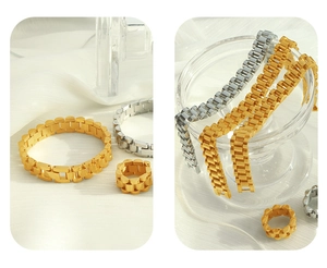 Close-up of gold and silver watchband style chain bracelets and rings on white cloth