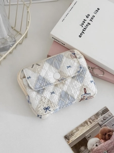 Detailed close-up of quilted floral coin purse with lace trim and secure snap closure