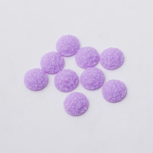 Macro detail of 12mm purple resin druzy cabochons for DIY jewelry making and crafts