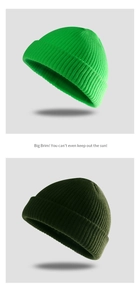 Detail of green and dark green knit beanies showing high-quality texture and stitching