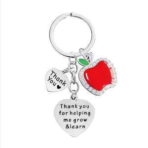 Silver apple keychain with engraved hearts thank you gift for teacher on white background
