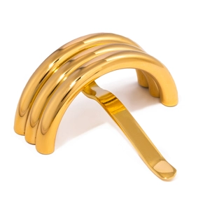 Close-up of polished gold U-shaped metal hair pin with triple-layer curved structure