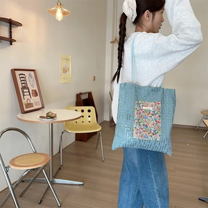 Blue sequin canvas tote bag featuring floral lace pocket detail shown in lifestyle setting