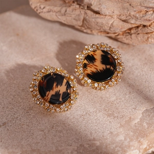 Detailed view of vintage leopard resin stud earrings with sparkling crystal accents