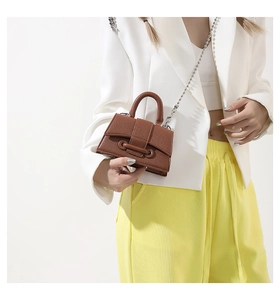 Brown leather mini square bag with beaded chain strap shown on professional model