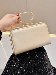 Detail of champagne gold evening clutch with crystal clasp and unique metal handle