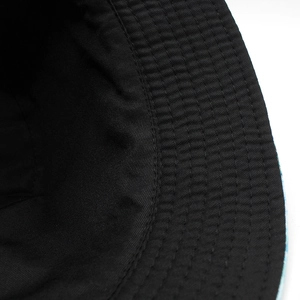 Close-up of reinforced stitching and durable cotton lining on a black bucket hat