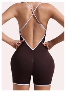 Detail of cross-back white straps and ribbed fabric on a coffee yoga bodysuit