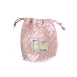 Pink quilted heart drawstring storage bag for cameras and small gadgets on white background