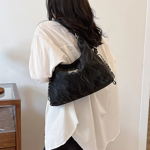 Versatile black pleated crossbody bag with silver butterfly buckle and chain strap