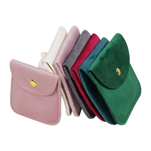 Multi-colored velvet jewelry pouches with gold snap buttons for rings and necklaces