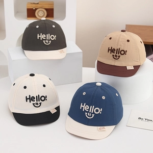 Detail of multi-color kids baseball caps with Hello embroidery and contrast brims