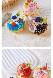 Detailed view of colorful realistic cream cake pendants with fruit slices and gold chains
