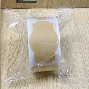 Detail view of kraft paper adhesive labels on a roll in transparent plastic packaging