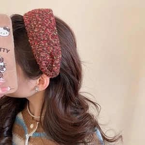 Detail of red-brown tweed knit headband with pearl necklace and snowflake earring