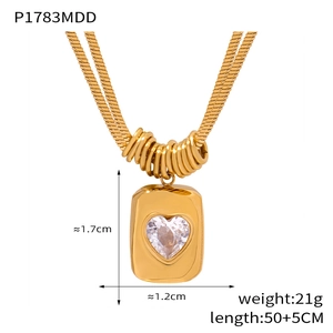 Detailed view of gold rectangle pendant with heart crystal on double snake chain necklace