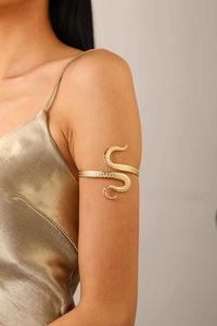 Detailed view of octopus tentacle arm cuff with suction cup texture in gold finish