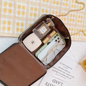 Sweet piano-style crossbody bag with bow detail showing interior capacity and chain strap