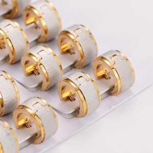 Minimalist matte gold and brushed silver stainless steel hoop earrings in a neat row