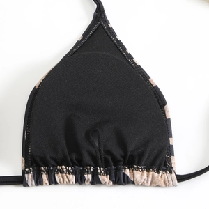 Detail view of bikini top interior featuring removable padding slots and leopard trim