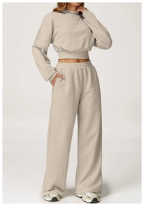 Detail view of beige high waist wide leg sweatpants with ribbed cuffs and elastic waistband