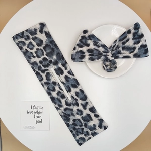 Detail showing leopard print fabric hair bun maker and bow tie accessory set